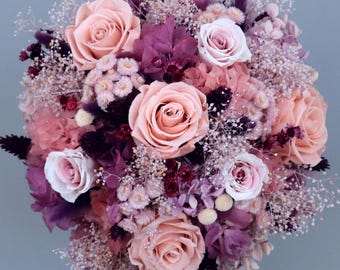Dreamlike bridal bouquet of dried flowers in violet, lilac, shades of purple, cream and white with stabilized roses