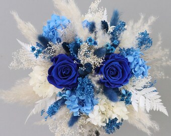 Bridal bouquet of dried flowers in blue, cream and white with stabilized roses