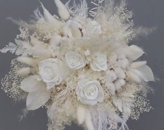 Elegant bridal bouquet of dried flowers in cream and white with stabilized roses