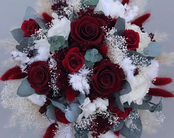 Bridal bouquet of dried flowers in burgundy, cream and white with preserved roses