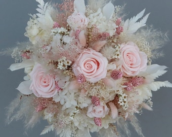 Fantastic bridal bouquet of dried flowers in pastel tones with stabilized roses