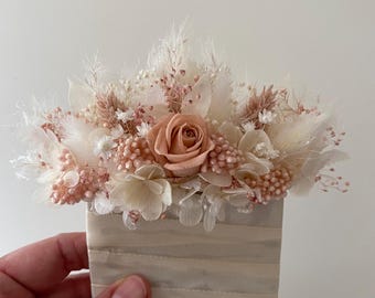 A boutonniere for the groom to match the bride's bouquet.