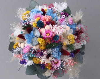 Delicate colorful meadow flower bridal bouquet made of dried flowers