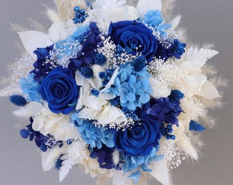 Bridal bouquet of dried flowers in blue, cream and white with stabilized roses