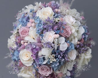 Bridal bouquet of dried flowers in pastel shades with stabilized roses
