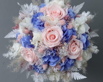 Dreamlike bridal bouquet of dried flowers in pastel shades with stabilized roses