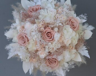 Dreamlike bridal bouquet of dried flowers in pastel shades with stabilized roses