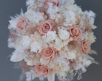 Dreamlike bridal bouquet of dried flowers in pastel shades with stabilized roses