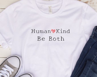 May include: White t-shirt with the text "Human Kind Be Both" and a red heart graphic.