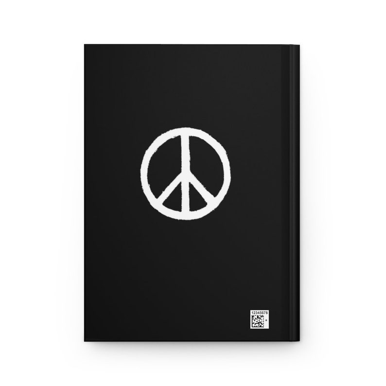 May include: Black notebook with a white peace sign in the center. The notebook has a barcode on the bottom right corner.
