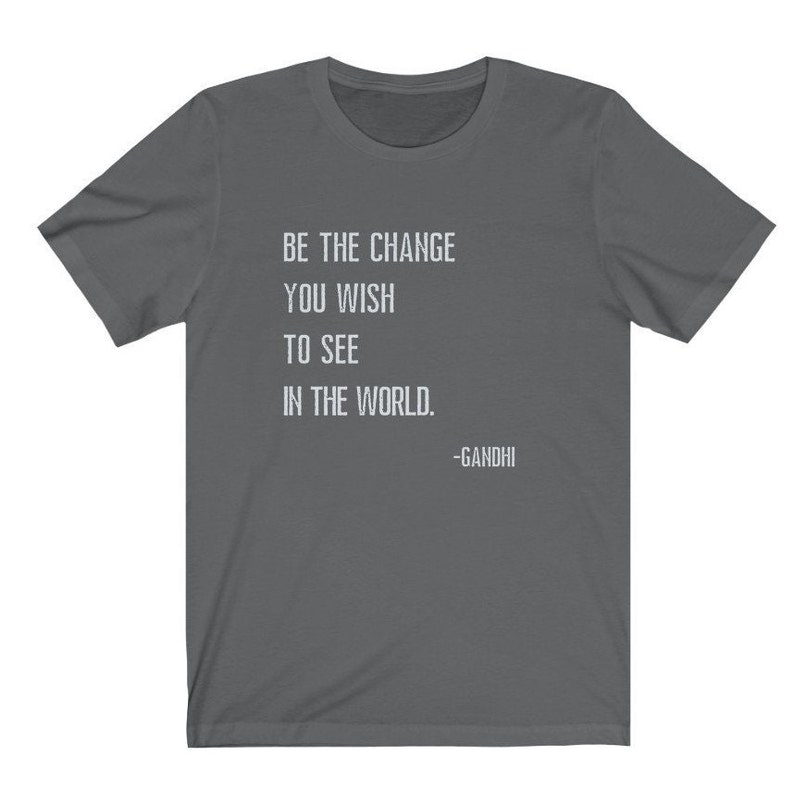 May include: A dark gray t-shirt with the quote "Be the change you wish to see in the world. -Gandhi" printed in white.