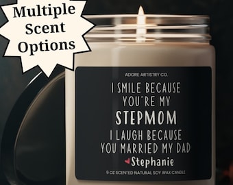May include: A soy wax candle with a black label that reads "I smile because you're my stepmom. I laugh because you married my dad. Stephanie." The candle is in a clear glass jar with a lid.