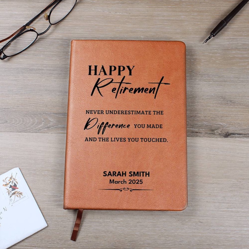 May include: A brown leather journal with the text "HAPPY Retirement NEVER UNDERESTIMATE THE Difference YOU MADE AND THE LIVES YOU TOUCHED." and the name "SARAH SMITH March 2025" embossed on the front.