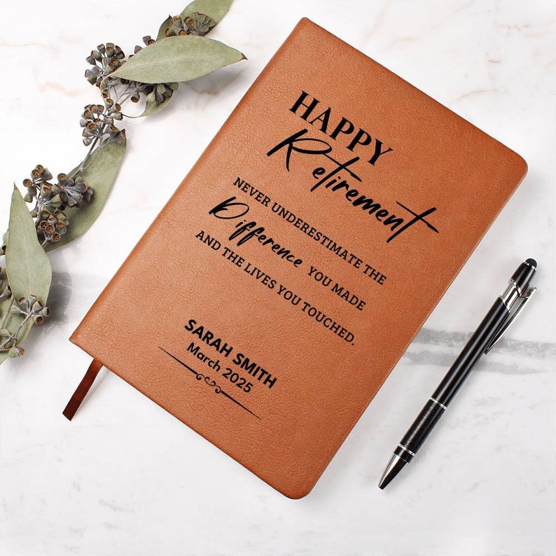May include: A brown leather-bound journal with the text "HAPPY Retirement NEVER UNDERESTIMATE THE Difference YOU MADE AND THE LIVES YOU TOUCHED." and the name "SARAH SMITH March 2025" engraved on the front cover.