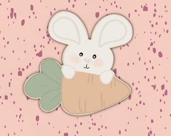 May include: A white bunny rabbit holding a carrot with green leaves on a pink background with pink speckles.