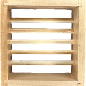 May include: A wooden soap dish with a slatted design. The dish is made of natural wood and has a light brown color.