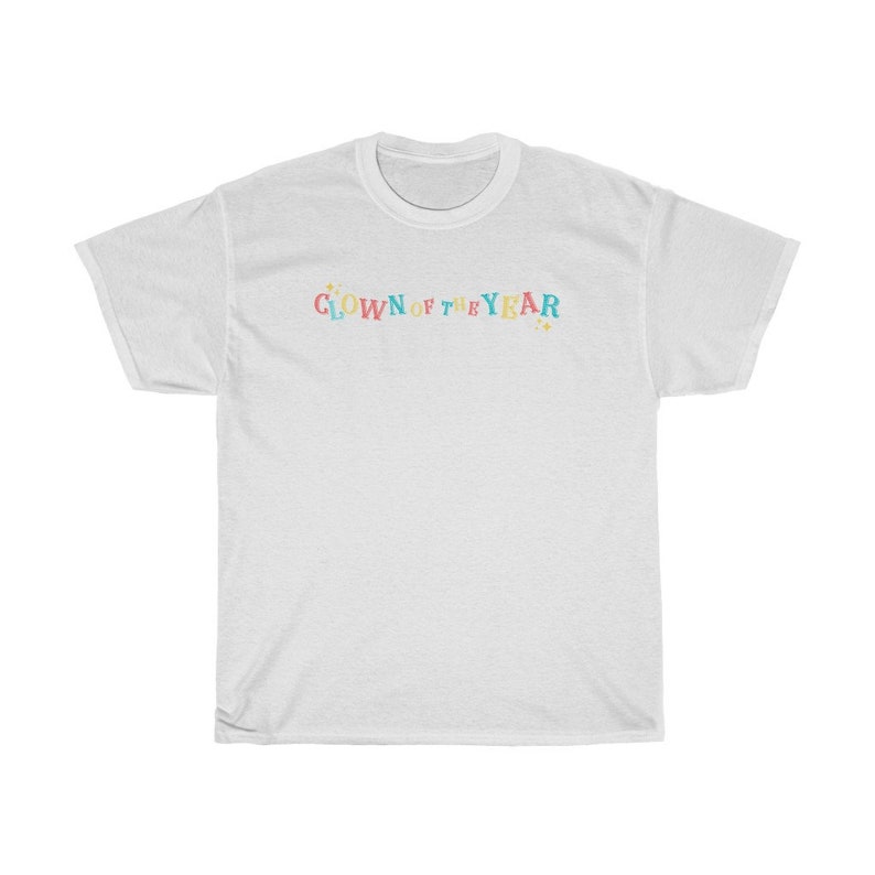 May include: White t-shirt with the text "CLOWN OF THE YEAR" in colorful letters with stars on either side.