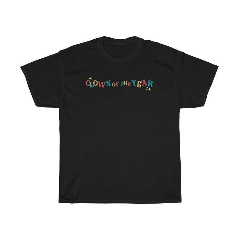 May include: Black t-shirt with the text "CLOWN OF THE YEAR" in colorful letters with yellow stars on either side.