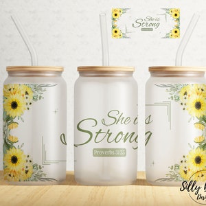 May include: Three frosted glass tumblers with bamboo lids and straws. Each tumbler features a floral design with sunflowers and greenery. The tumblers have the text "She is Strong Proverbs 31:25" printed on them.