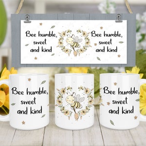 Puede incluir: Tres tazas de cerámica blanca con un diseño de abeja y flores. Las tazas tienen el texto "Bee humble, sweet and kind" impreso en ellas.