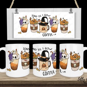May include: Two white ceramic mugs with a Halloween theme. The mugs feature a design of coffee cups with pumpkins, skulls, and a witch's hat. The text on the mugs reads "Scary til I get coffee".