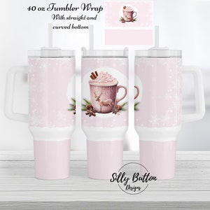 May include: A pink 40 ounce tumbler wrap with a design of a hot chocolate with whipped cream and a reindeer. The text "40 oz Tumbler Wrap" and "With straight and curved bottom" is at the top of the image. The text "Silly Button Designs" is at the bottom of the image.