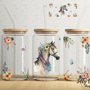 May include: Three glass jars with wooden lids and straws. Each jar has a different floral design with a watercolor horse, butterflies, and flowers. The jars are labeled "Silly Button Designs".