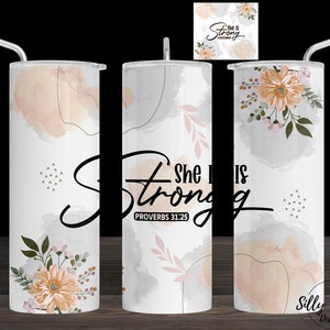 May include: A set of three stainless steel tumblers with a watercolor background and floral designs. The tumblers feature the text "She is Strong" and "Proverbs 31:25".