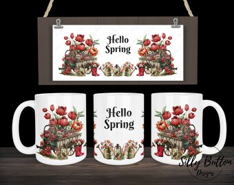 May include: White ceramic mug with a colorful illustration of a wheelbarrow filled with red and pink flowers, green leaves, and gardening tools. The text "Hello Spring" is printed on the mug.