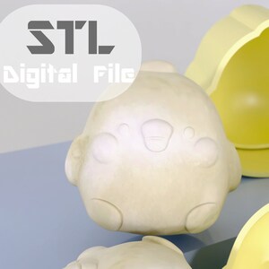 以下が含まれることがあります： ひよこの形をした黄色いシリコンモールドが3つ。モールドは、小さなケーキやその他の御馳走を作るように設計されています。モールドは青と白の表面にあります。STLデジタルファイル。