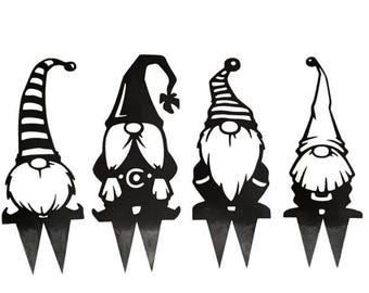 May include: Set of four black metal garden gnome silhouettes. Each gnome has a different hat design. The gnomes are approximately 10 inches tall.