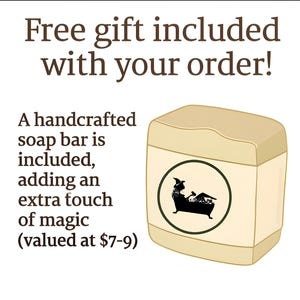 May include: A handcrafted soap bar is included with your order. The image shows a beige rectangular soap bar with a circular label featuring a black silhouette of a person in a bathtub. Text on the image reads "Free gift included with your order!"