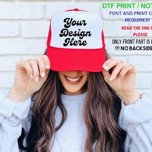 May include: A red and white trucker hat featuring the black text Your Design Here on the front panel. The hat includes text overlays stating DTF PRINT / NOT PUFF, FONT AND PRINT COLOR REQUIRED!, READ THE 2ND CHART PLEASE, and ONLY FRONT PART IS PRINTABLE !!! NO BACKSIDE PRINT.