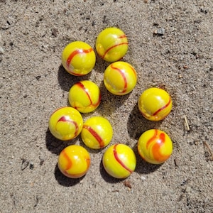 10 machine made yellow red marbles 1.3 and 1.4 cm (0.51 and 0.55 inch)