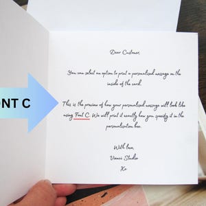 May include: An open greeting card with handwritten text. The text includes "Dear Customer," and a preview of how a personalised message will look using Font C. A blue and green arrow points to the text "FONT C."