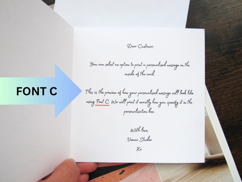 May include: An open greeting card with handwritten text. The text includes "Dear Customer," and a preview of how a personalised message will look using Font C. A blue and green arrow points to the text "FONT C."