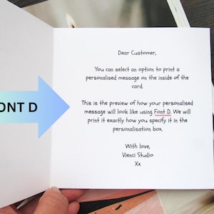 May include: An open greeting card with text. The card's interior features a message preview, with the text "Font D" and an arrow pointing to the text. The card's message is in black font.