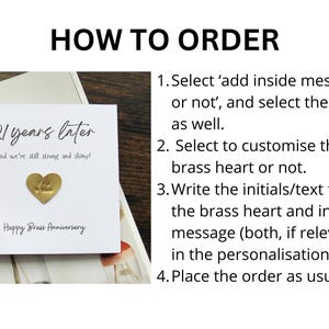 May include: A white card with the text "21 years later" and "Happy Brass Anniversary". A gold heart-shaped charm is affixed to the card. Instructions on how to order are listed on the right.