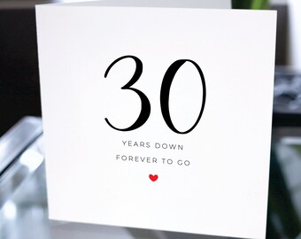 May include: A white card with black text that reads "30 years down forever to go" with a small red heart below the text.