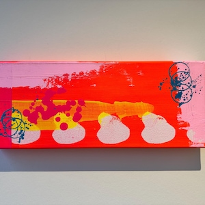 May include: Abstract painting on canvas with pink, red, yellow, and blue paint. The painting features a series of overlapping circles and abstract shapes.