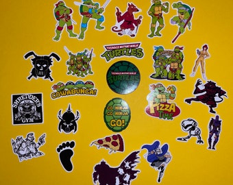 May include: A collection of Teenage Mutant Ninja Turtles stickers featuring various characters, logos, and phrases. The stickers are on a yellow background. The stickers include the Teenage Mutant Ninja Turtles logo, the phrase "Cowabunga!" and the phrase "Pizza Time".
