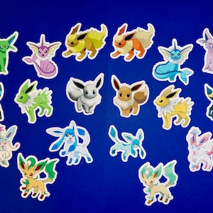 May include: A collection of 17 colorful Pokemon stickers featuring various characters from the popular anime and video game franchise. The stickers are printed on white paper with a glossy finish.