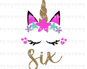 May include: A colourful unicorn design featuring a gold glitter horn, pink and black ears, and a floral crown in pink, blue, and purple. Below are eyelashes and the word "Six" in gold glitter.