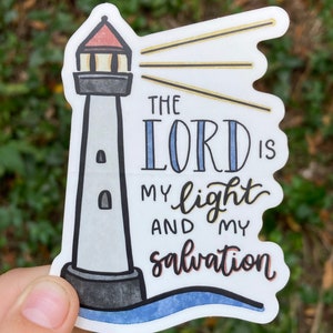 May include: A white sticker with a lighthouse illustration and the text "The Lord is my light and my salvation".
