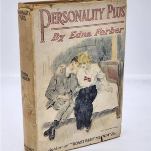 May include: A vintage book cover with a drawing of a couple sitting on a bed. The book title is "Personality Plus" by Edna Ferber. The author is also listed as the author of "Roast Beef Medium" etc.