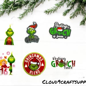 May include: Five different Grinch-themed Christmas stickers. The stickers feature the Grinch in various poses and with different sayings, including "Resting Grinch Face" and "Grinchmas Blend".