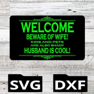 May include: Black and green welcome sign with the text "WELCOME BEWARE OF WIFE! KIDS AND PETS ARE ALSO SHADY HUSBAND IS COOL!"  SVG and DXF file formats are shown below the sign.