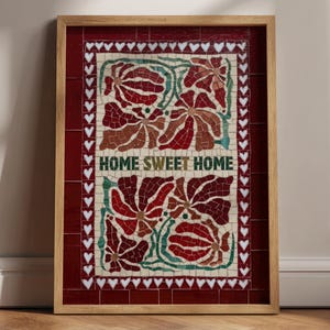 May include: Framed mosaic art with a wooden frame. The mosaic features a floral design in shades of red, brown, and green, with the words "HOME SWEET HOME" in white. The border is a deep red with white heart accents.