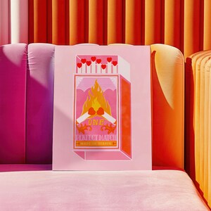 May include: A pink and orange illustration of a matchbox with the text "One Perfect Match Made in Heaven". The matchbox is on fire with two hearts at the top of the flames.