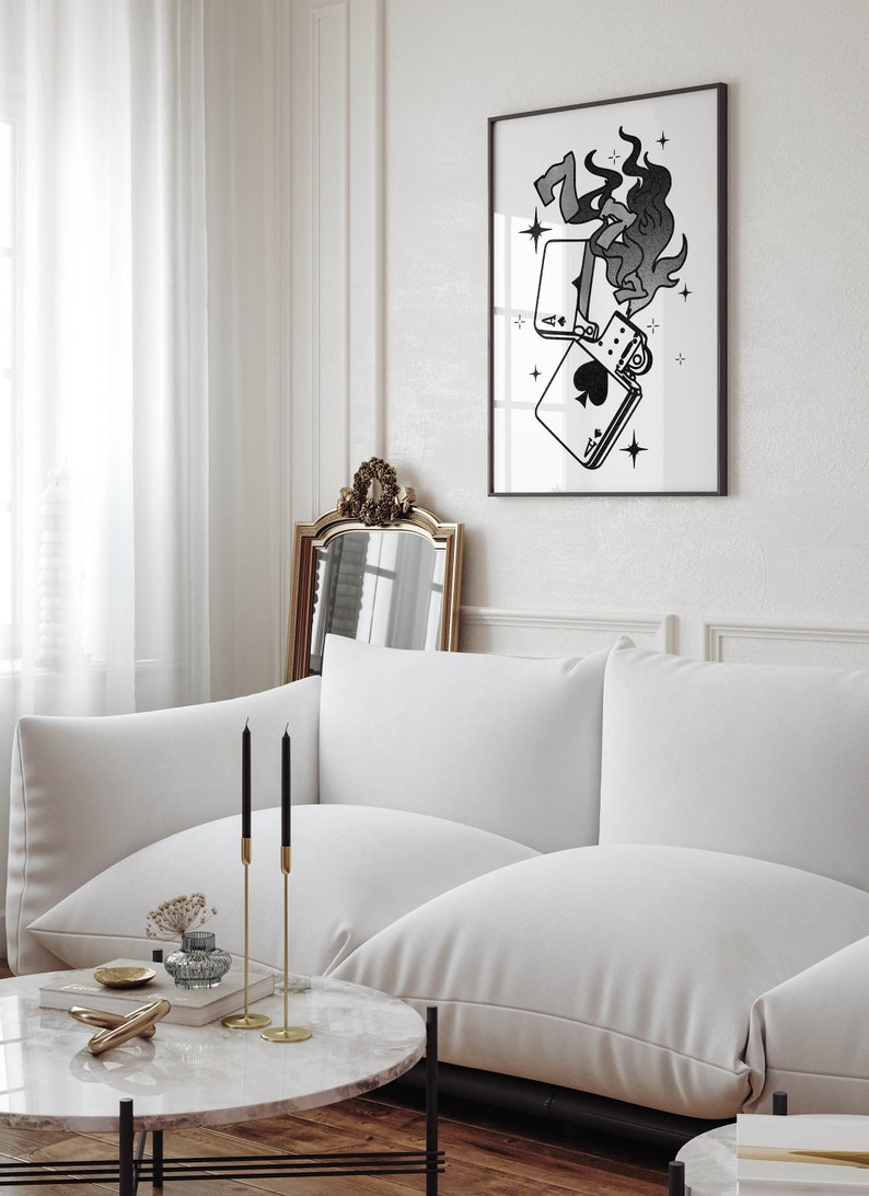 May include: A black and white illustration of a lighter with flames and playing cards, printed on a white background and framed in a black frame.